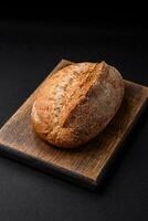 Delicious fresh baked crispy loaf of bread with seeds and grains photo