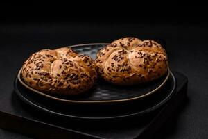 Delicious freshly baked crispy bun or kaiser roll with sesame seeds photo