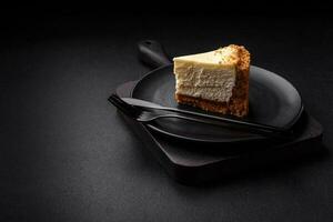 Delicious sweet cheesecake cake on textured concrete background photo