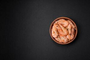 Delicious fresh boiled tiger prawns with salt and spices on a ceramic plate photo