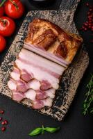 Delicious calorie smoked bacon with salt, spices and herbs photo