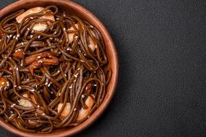 Delicious fresh buckwheat noodles with boiled tiger prawns, salt, spices and mushrooms photo