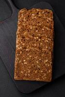 Delicious fresh crispy brown bread with seeds and grains cut into slices photo