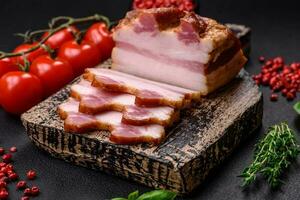 Delicious calorie smoked bacon with salt, spices and herbs photo