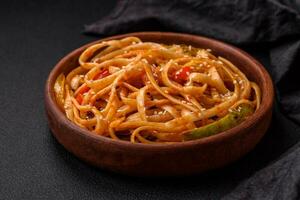 Delicious asian udon dish with vegetables, mushrooms, salt and spices photo