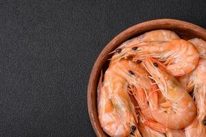 Delicious fresh boiled tiger prawns with salt and spices on a ceramic plate photo