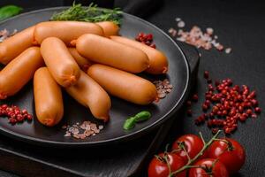 Delicious fresh boiled sausages with salt, spices and herbs photo
