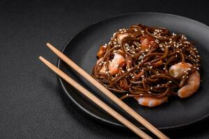 Delicious fresh buckwheat noodles with boiled tiger prawns, salt, spices and mushrooms photo