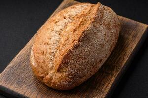 Delicious fresh baked crispy loaf of bread with seeds and grains photo