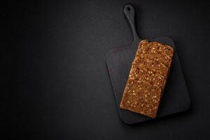 Delicious fresh crispy brown bread with seeds and grains cut into slices photo