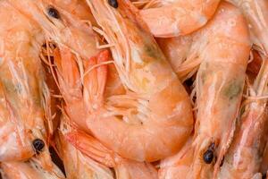 Delicious fresh boiled tiger prawns with salt and spices on a ceramic plate photo