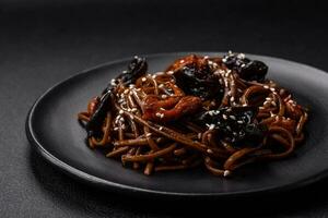 Delicious fresh buckwheat noodles or udon with mushrooms, peppers and other vegetables photo