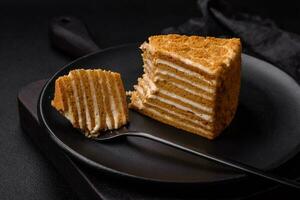 Delicious fresh sweet honey cake layer cake with white cream photo