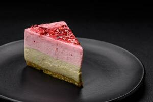 Delicious sweet dessert cheesecake with raspberry and pistachio flavor photo