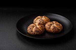 Delicious freshly baked crispy bun or kaiser roll with sesame seeds photo