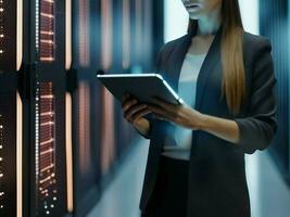 Female data center IT specialist using tablet computer photo
