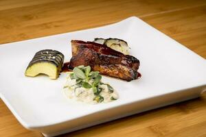 delicious grilled pork bbq rib served on white plate - gourmet photo