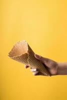 Young woman holding ice cream cone - yellow background photo