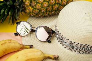 Beach hat and sunglasses for women, concept of relaxing summer vacations - close up. photo