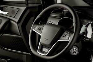 Steering wheel of a new car, interior cabin, luxurious details - mode of transport photo