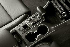 Automatic gear lever inside a new car, top view photo