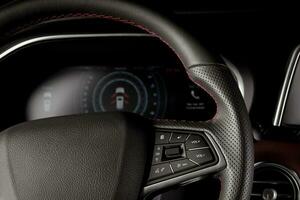 Interior modern car with new technology, leather steering wheel and digital speedometer display photo