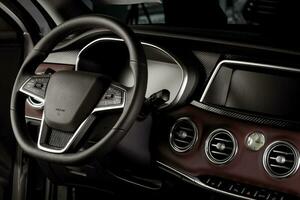 Electric car interior with digital speedometer and touch center console display, leather-wrapped steering wheel photo