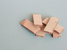 stack of chocolate wafers on a gray background with copy space photo