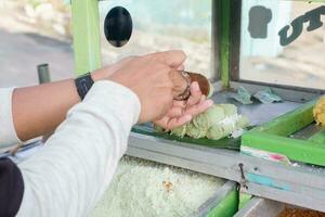 the process of making a traditional Indonesian cake called putu photo