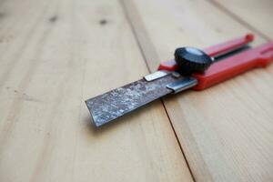 selective focus to the rusty blade of the cutter. dangerous can cause tetanus also scratched on the skin. Hand tools. red construction knife with blades photo