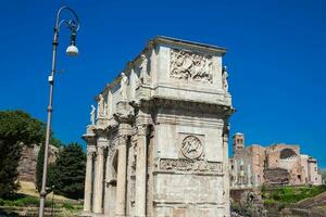 The Arch of Constantine a triumphal arch in Rome, situated between the Colosseum and the Palatine Hill built on the year 315 AD photo