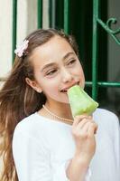 Young girl eating a traditional water ice cream typical of the Valle del Cauca region in Colombia photo