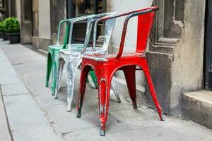 Three empty rickety colorful chairs at the historical streets of Florence photo