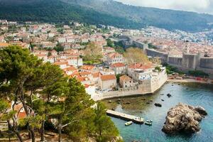 Dubrovnik West Pier and medieval fortifications of the city seen from Fort Lovrijenac photo