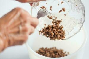 Step by step Levantine cuisine kibbeh preparation. Mixing the ingredients to prepare kibbeh filling into a bowl photo