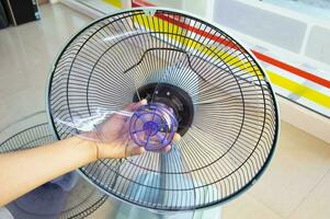 Technician repairing fan, replacing impeller photo