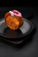 Round puff pastry croissant with raspberry filling or new york roll photo