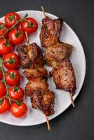 Delicious grilled chicken, turkey or pork skewers with salt, spices and herbs photo