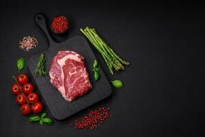 Fresh, raw beef steak with salt, spices and herbs photo