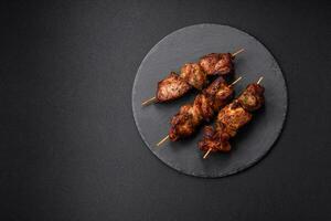 Delicious grilled chicken, turkey or pork skewers with salt, spices and herbs photo