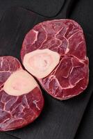 Fresh raw beef steak with bone or ossobuco with salt, spices and herbs photo