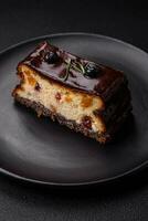 Delicious sweet dessert cheesecake with candied fruits in chocolate photo