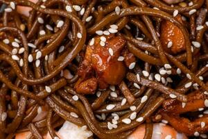 Delicious fresh buckwheat noodles with boiled tiger prawns, salt, spices and mushrooms photo