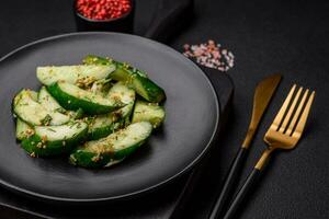 Delicious juicy cucumber cut into large slices with salt, spices and french mustard photo