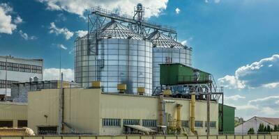 agro silos on agro-industrial complex and grain drying and seeds cleaning line. photo