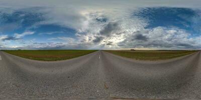 spherical 360 hdri panorama on old asphalt road with cracks with clouds and sun on evening blue sky in equirectangular seamless projection, as sky replacement in drone panoramas, game development photo