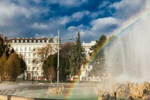 View of the beautiful buildings at Vienna city center and the fountain at Schwarzenbergplatz photo