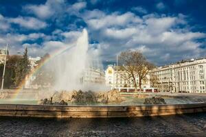 View of the beautiful buildings at Vienna city center and the fountain at Schwarzenbergplatz photo