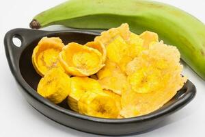 Raw plantain cups, patacones and pieces on white background photo