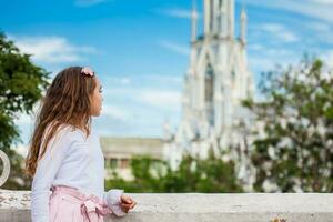 Beautiful young girl on the Ortiz Bridge looking at the famous gothic church of La Ermita in the city of Cali in Colombia photo